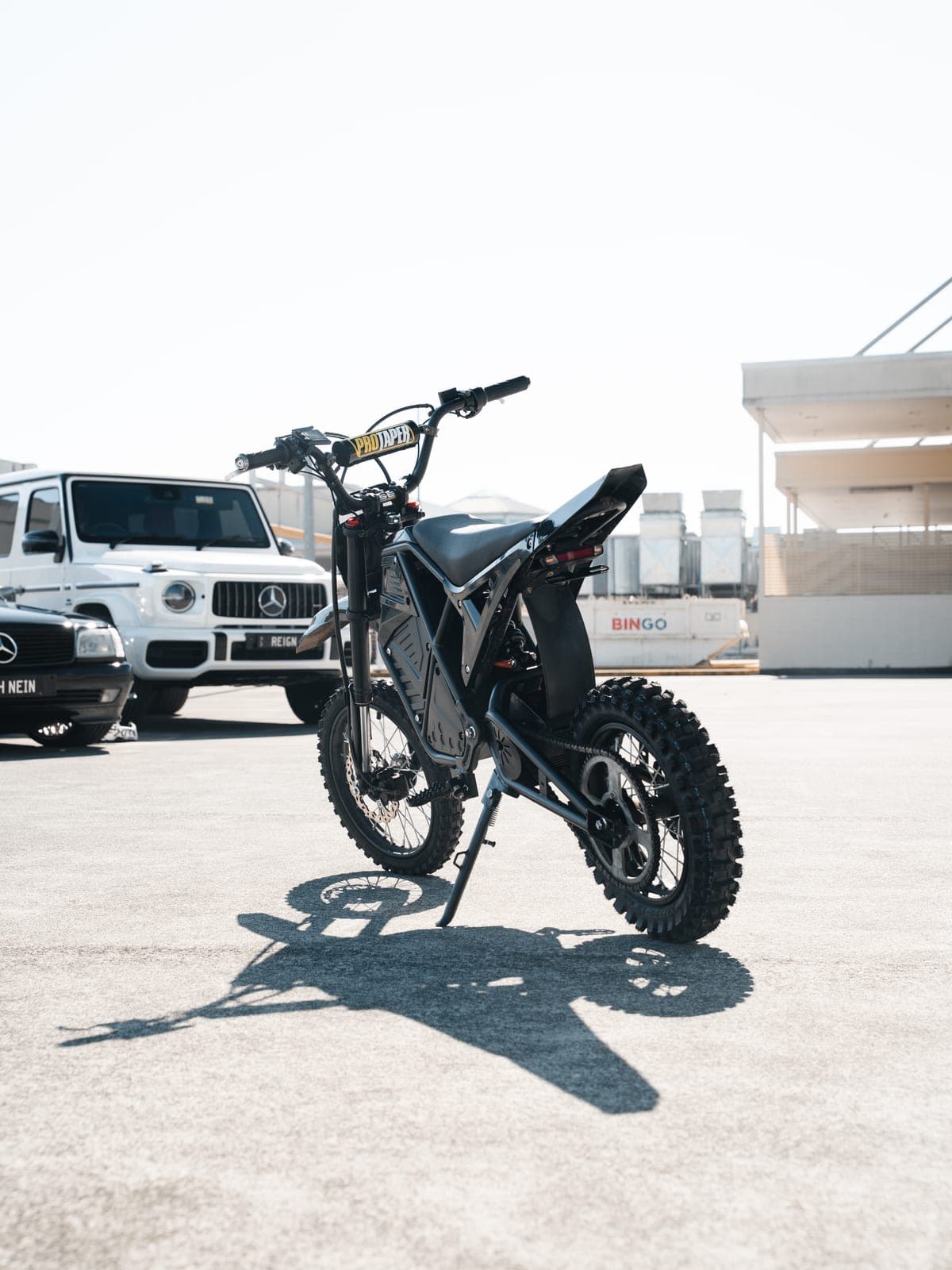 Revex MX electric dirt bike, rear three-quarter view